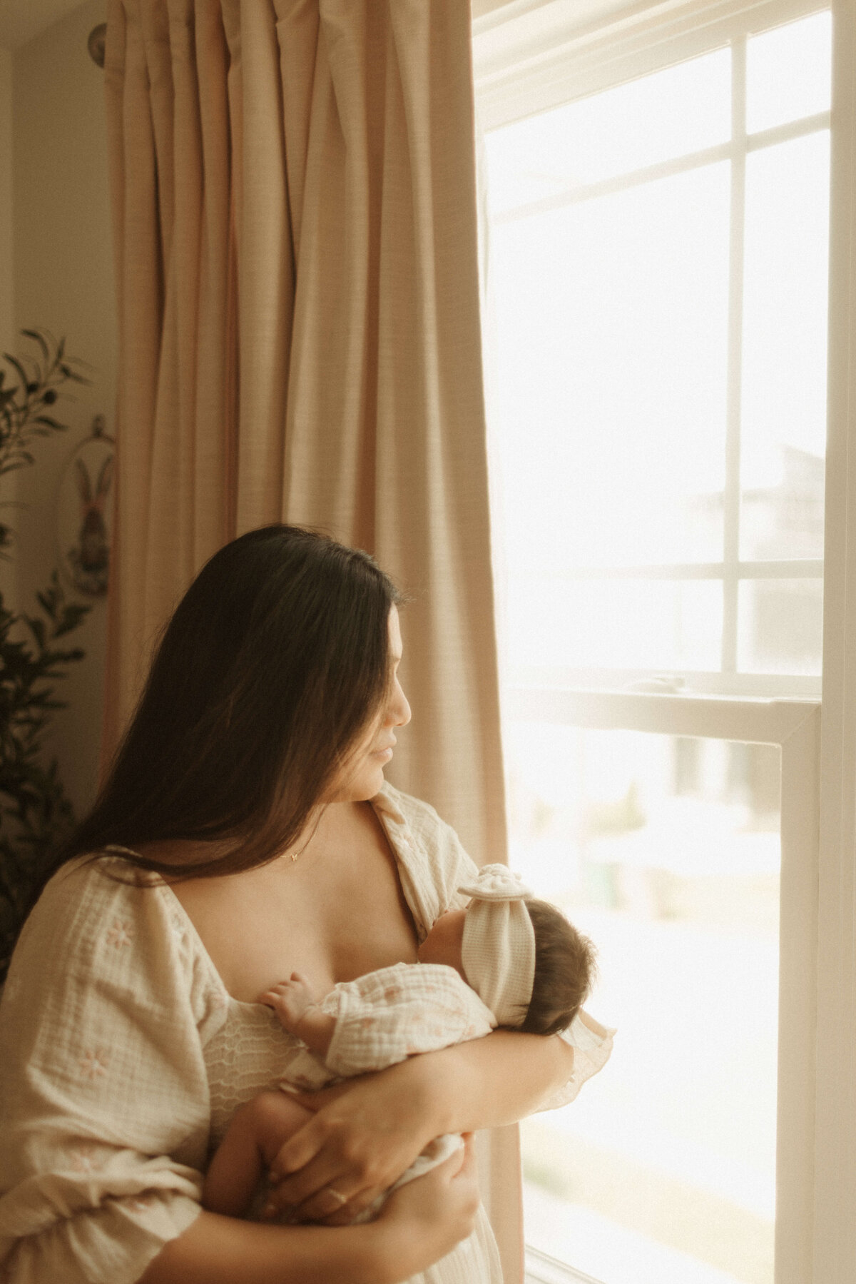 Newborn swaddled in cream wrap during Franklin Tennessee in-home lifestyle session