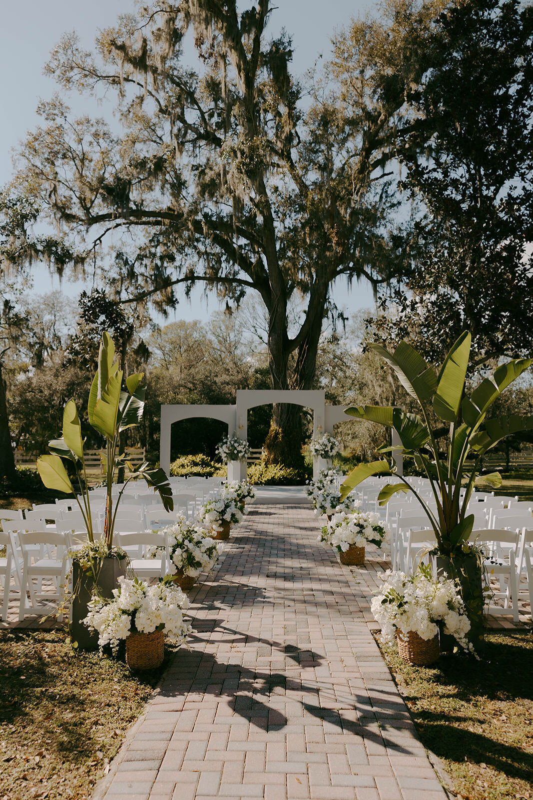 Beautiful tropical floral wedding altar setup at Uliana Estate, a romantic Lakeland wedding venue.