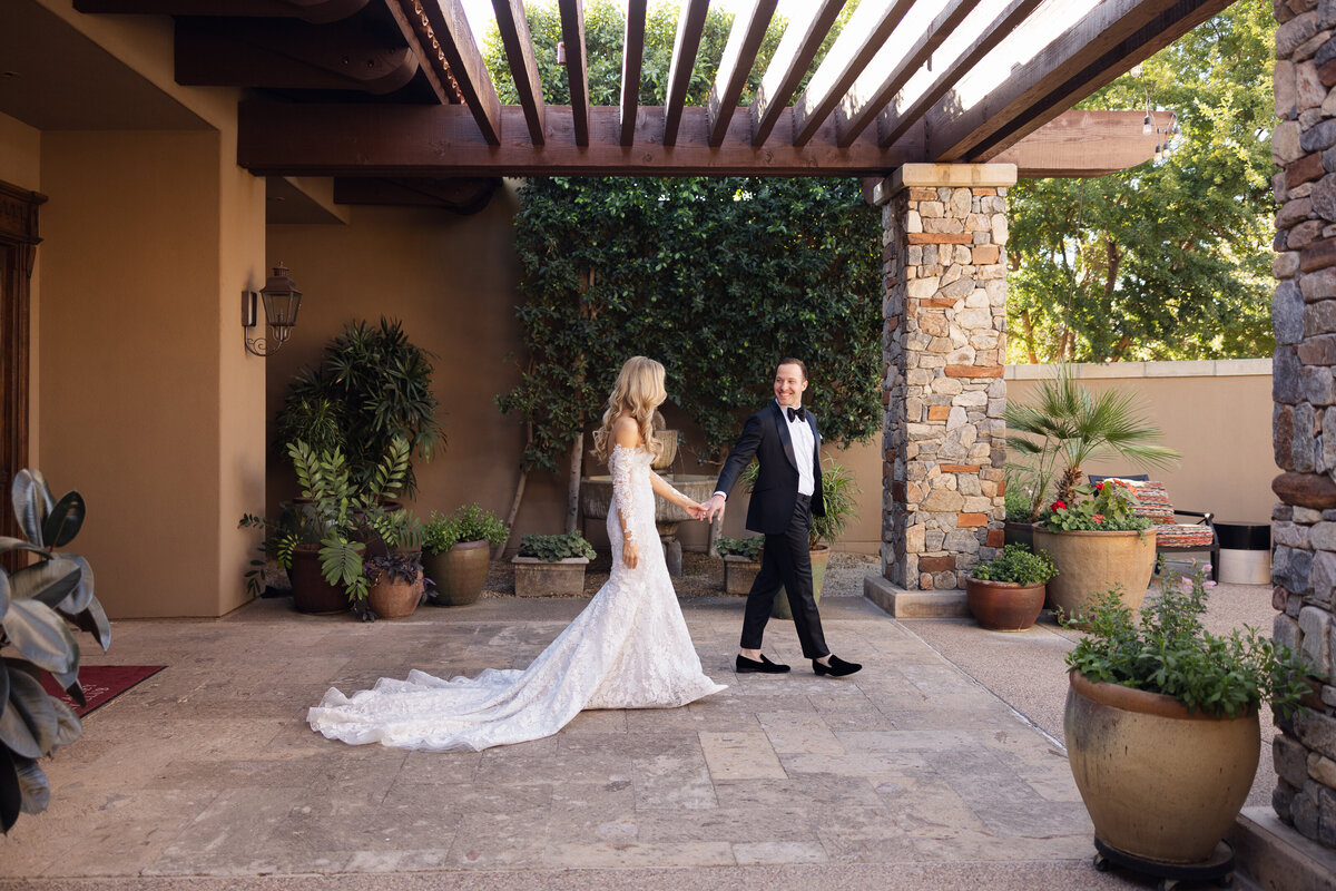 Bride and groom holding hands on wedding day at Paradise Valley Country Club in Arizona