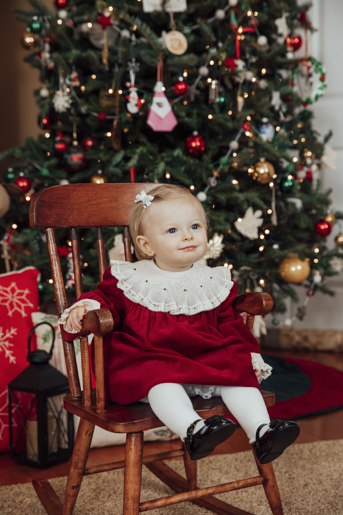 Christmas Portrait Photographer | One-year-old smiling during holiday photo session with festive décor | Hunterdon County, New Jersey