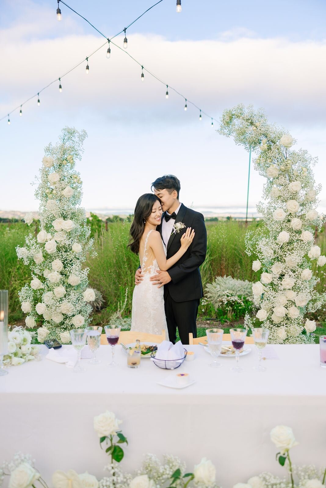 couple-in-floral-arch