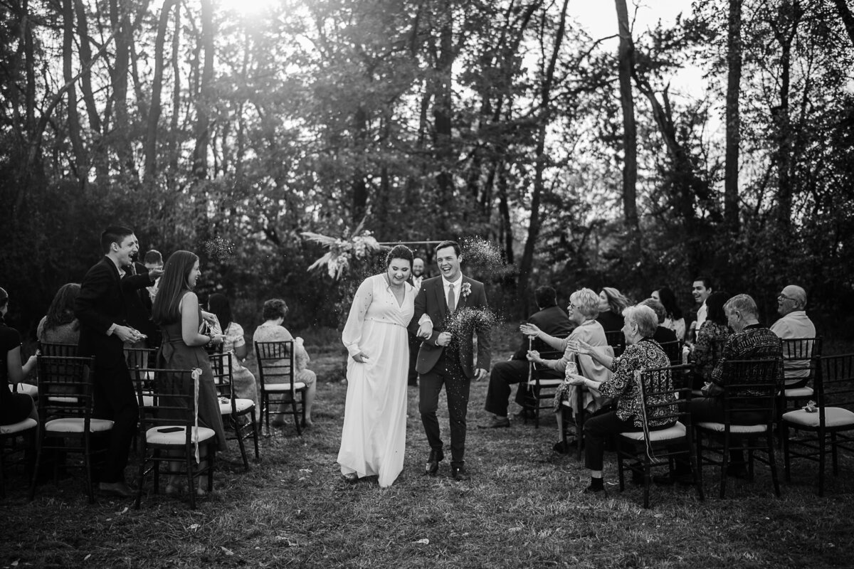 bride and groom under confetti
