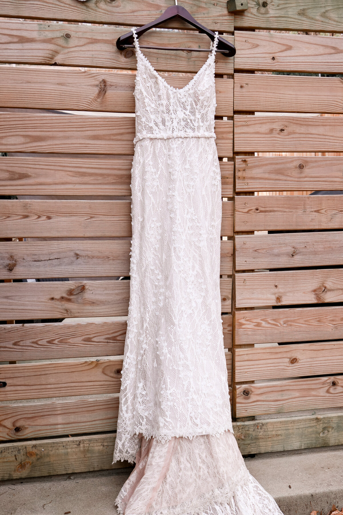 wedding dress hanging on fence in Alexandria Virginia by Washington DC elopement photographer Amanda Richardson Photography