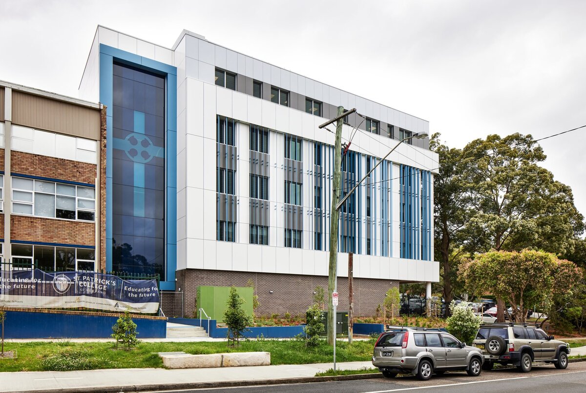 Front view of St Patrick’s School in Sutherland, NSW — a contemporary educational building featuring large glass windows and sleek architecture by Serlana Construction