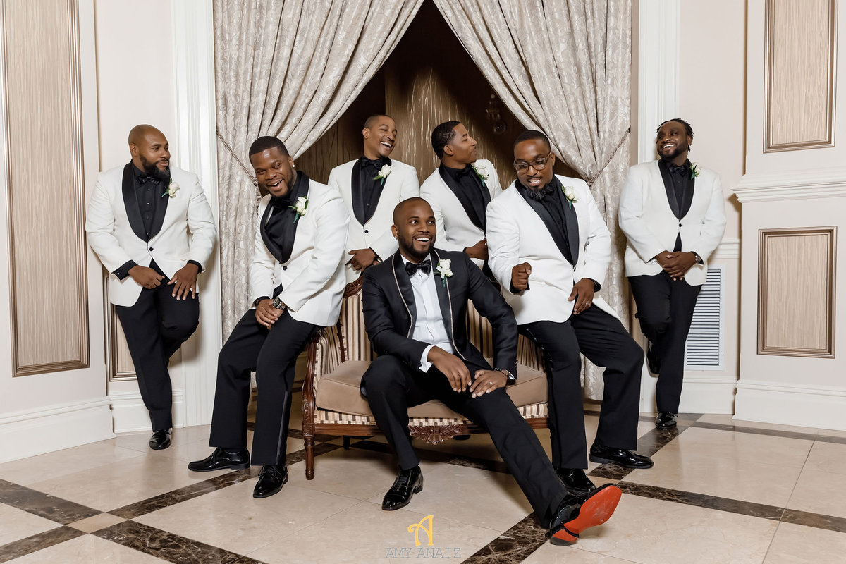 Groomsmen in white and black tuxes
