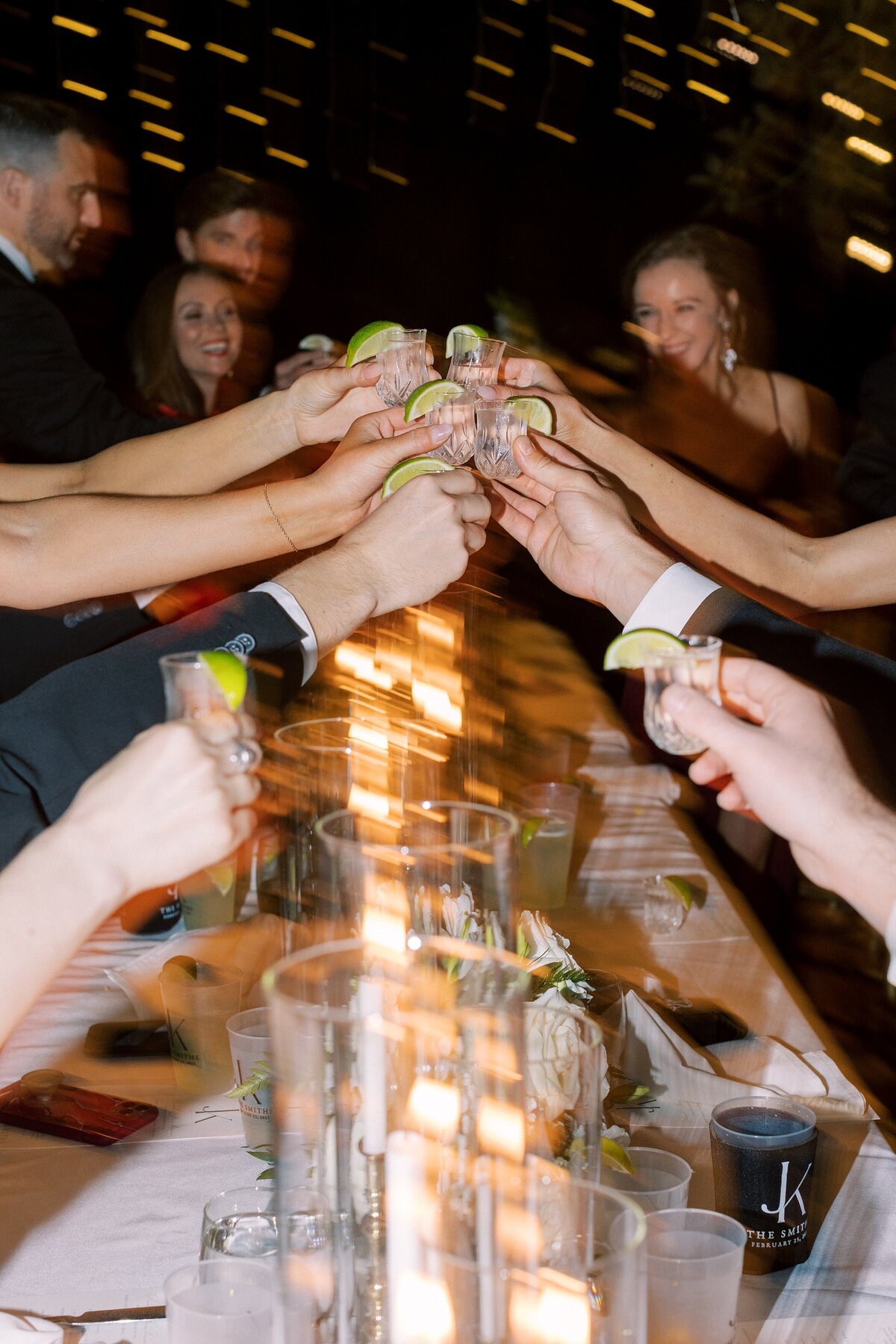 Guests clink glasses for a toast at a wedding reception