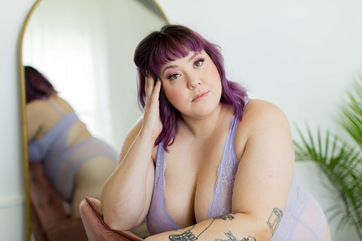 purple haired plus size woman stares into camera in Columbia SC boudoir photos