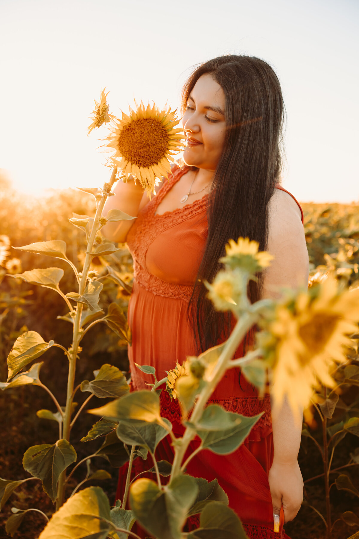 Maria poses with a sunflower for her Montrose senior pictures.