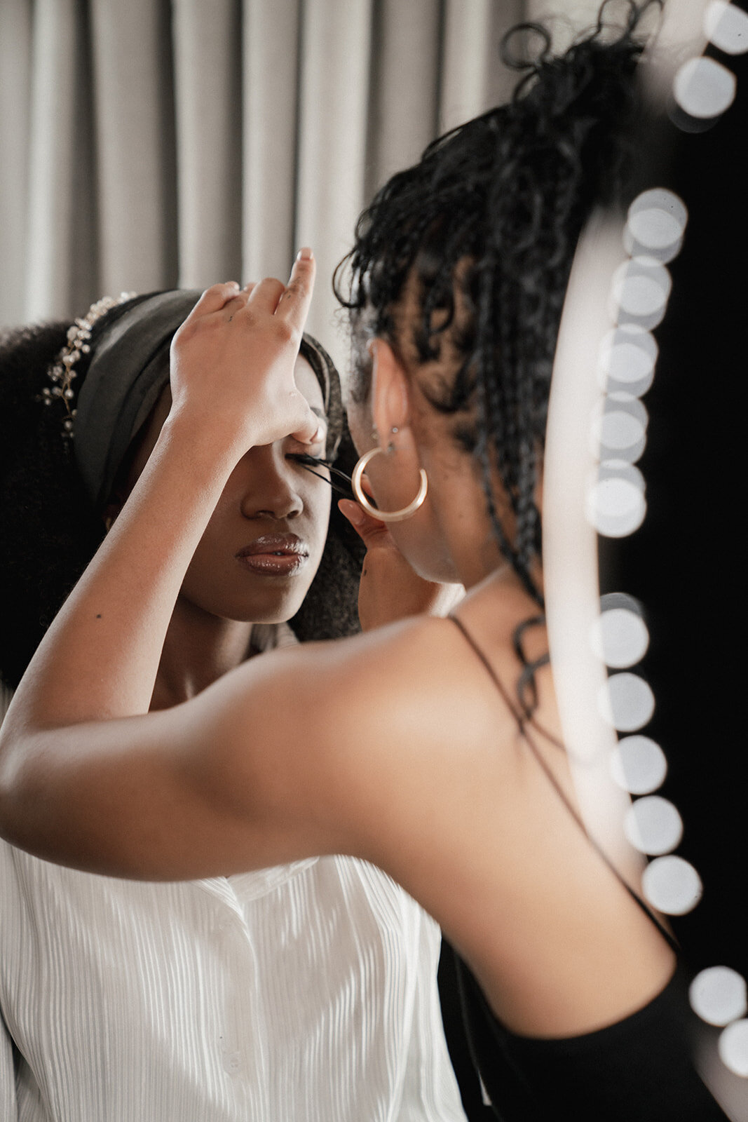 black bridesmaid getting ready for wedding with makeup