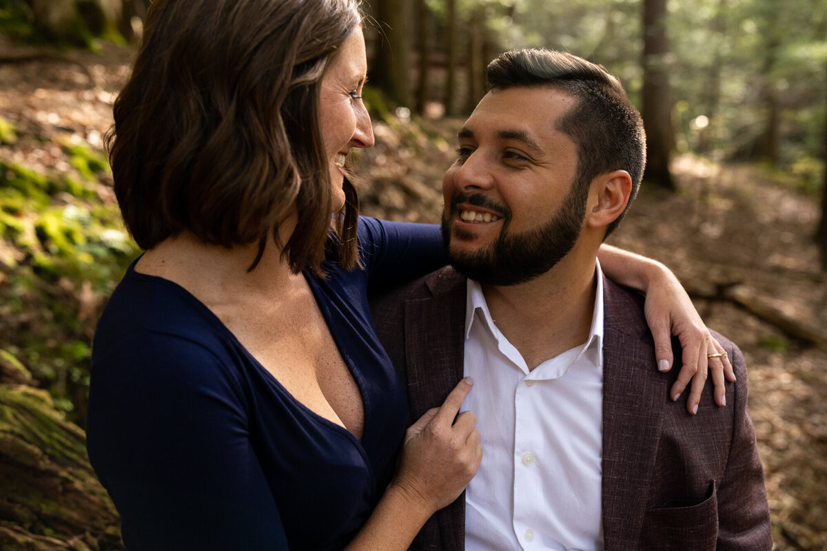 Couple snuggles during their engagement session at Hocking Hills State Park