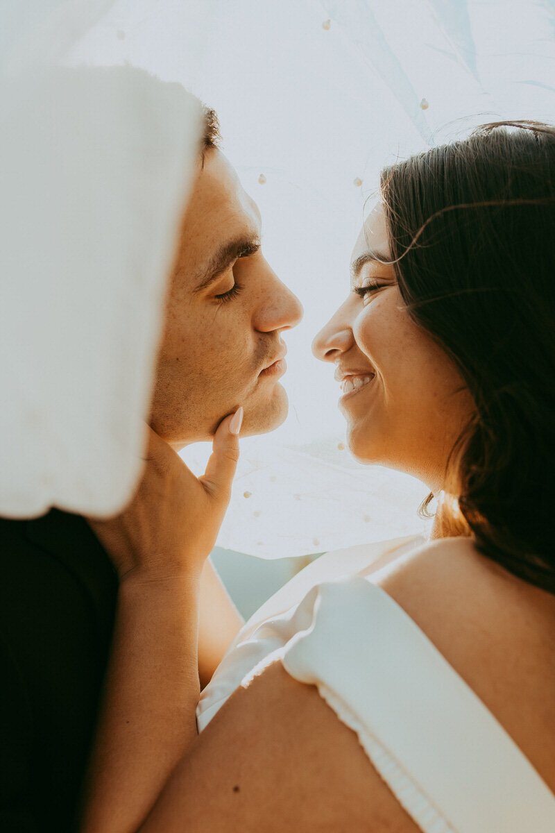 bridal couple smiles in a close up photo