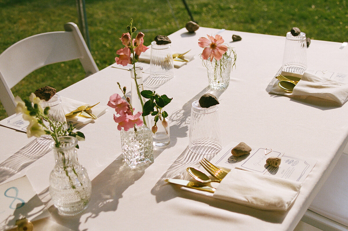 picture of reception table with flowers during golden hour on film