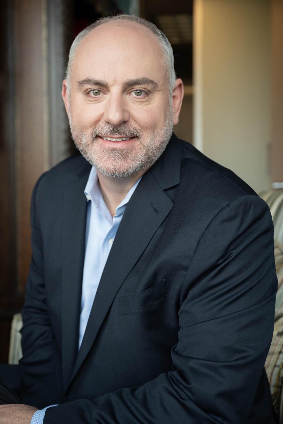 A headshot of a man looking straigh to the camera.