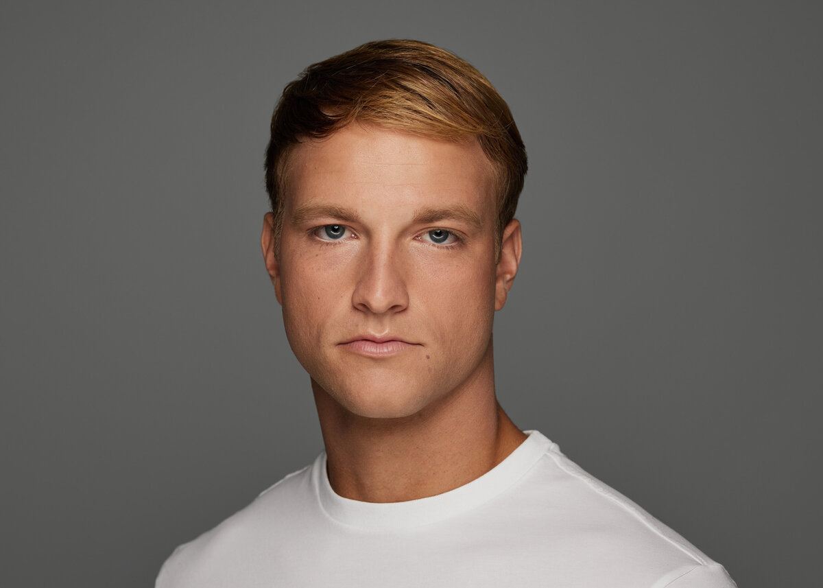 A man in a white shirt looking forward