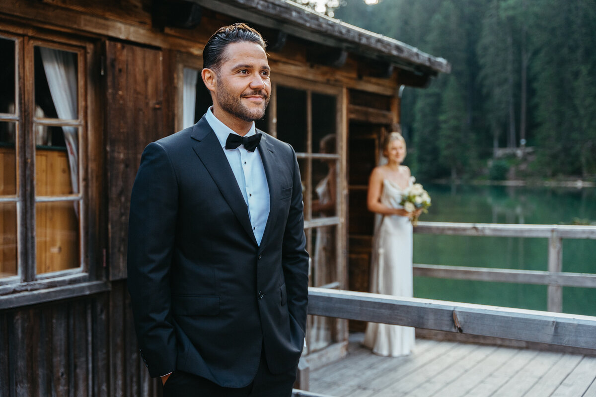 Bride holding bouquet on boathouse deck before first look