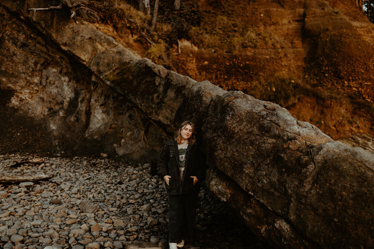 girl standing on rocky beach in Oregon
