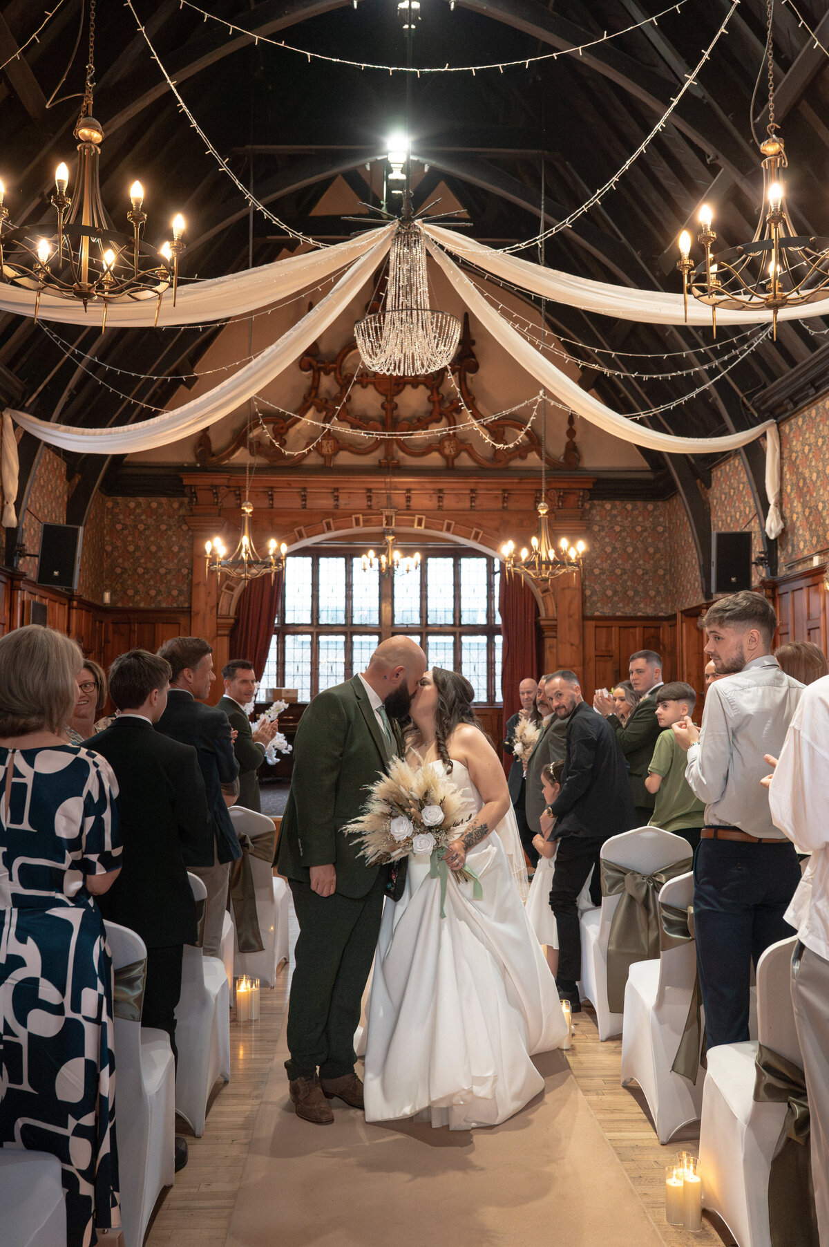 Bride and groom sharing a kiss during the exit at Worsley Court house - Manchester Wedding Photographer