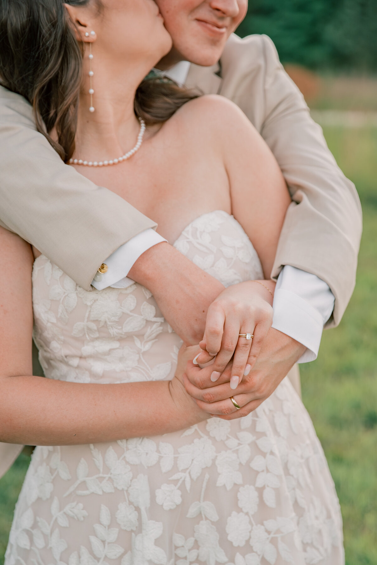 bride and groom embrace at Three Oaks Manor