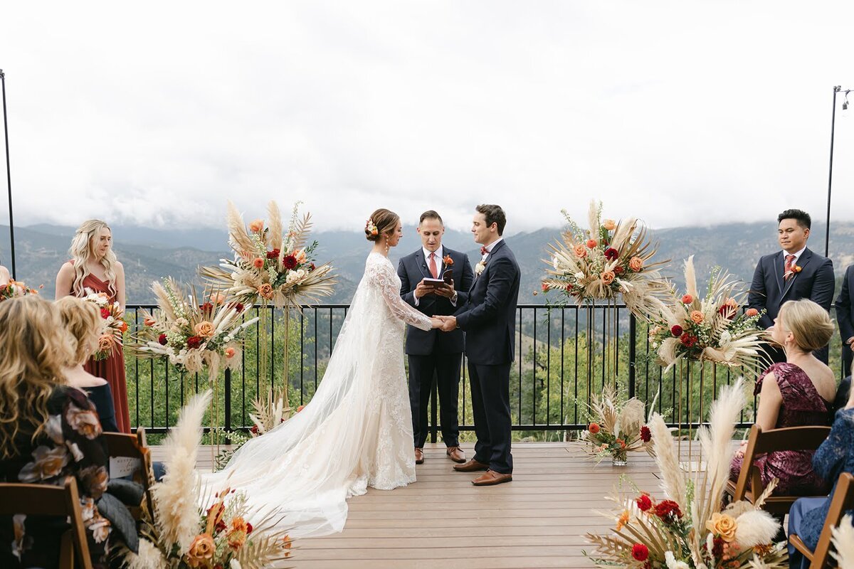 Wedding ceremony in the Colorado mountains with fall flowers at North Star Gatherings.