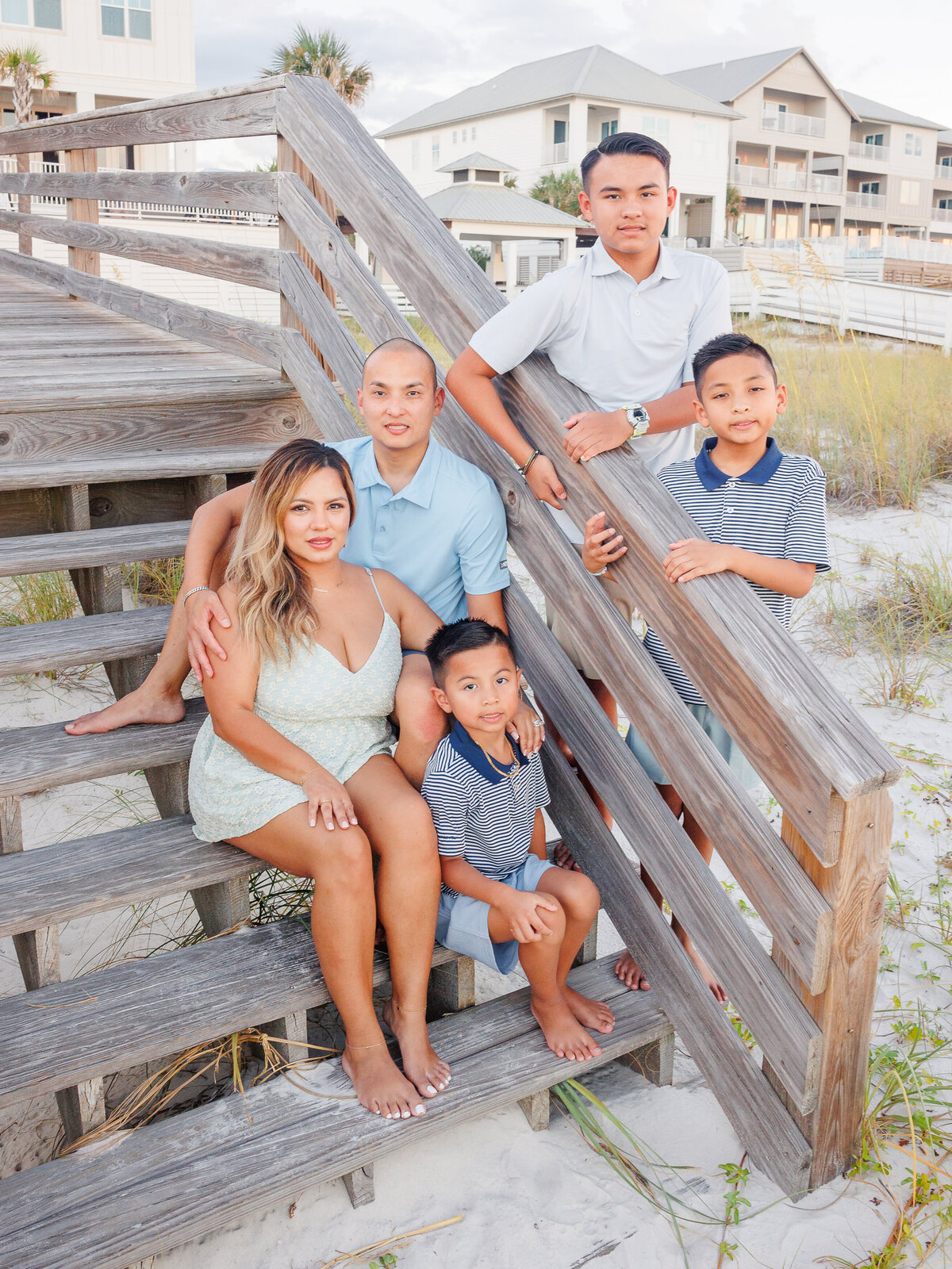 Family of five sitting idea on steps to boardwalk