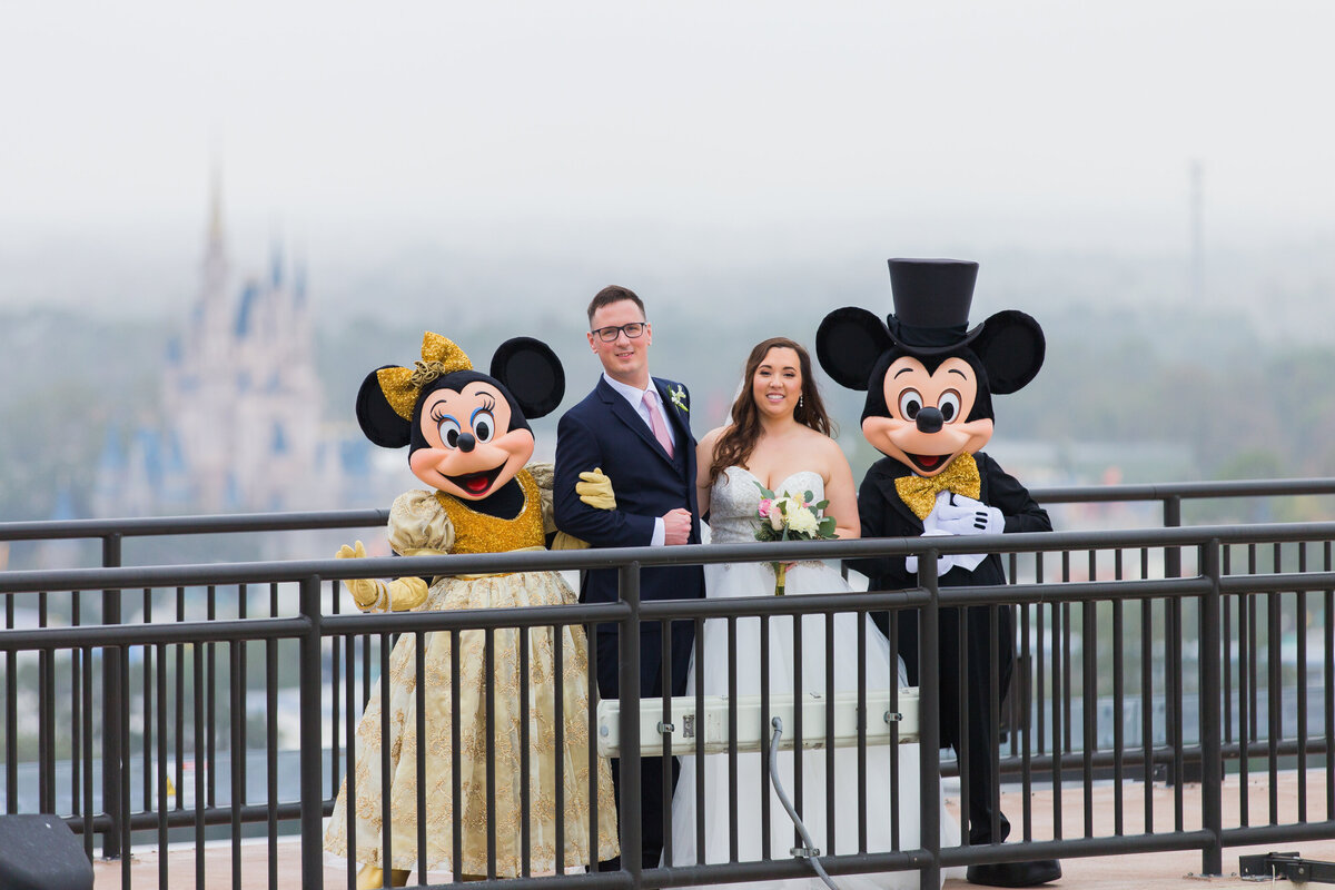 Wedding photo of couple with Minnie and Micky