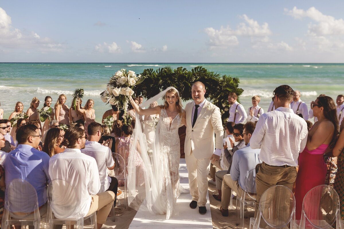 Bride and groom celebrate after wedding ceremony at wedding in Riviera Maya