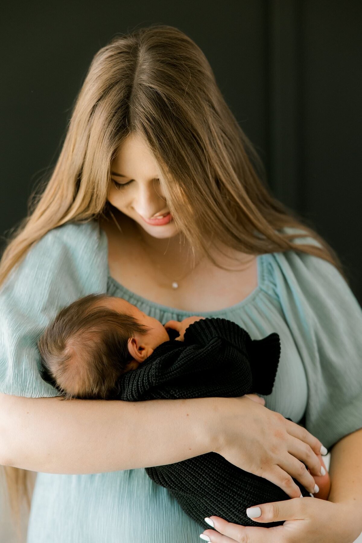 first time mom smiling at her baby boy, beautiful capture by Mary Wiebe a lubbock newborn photographer