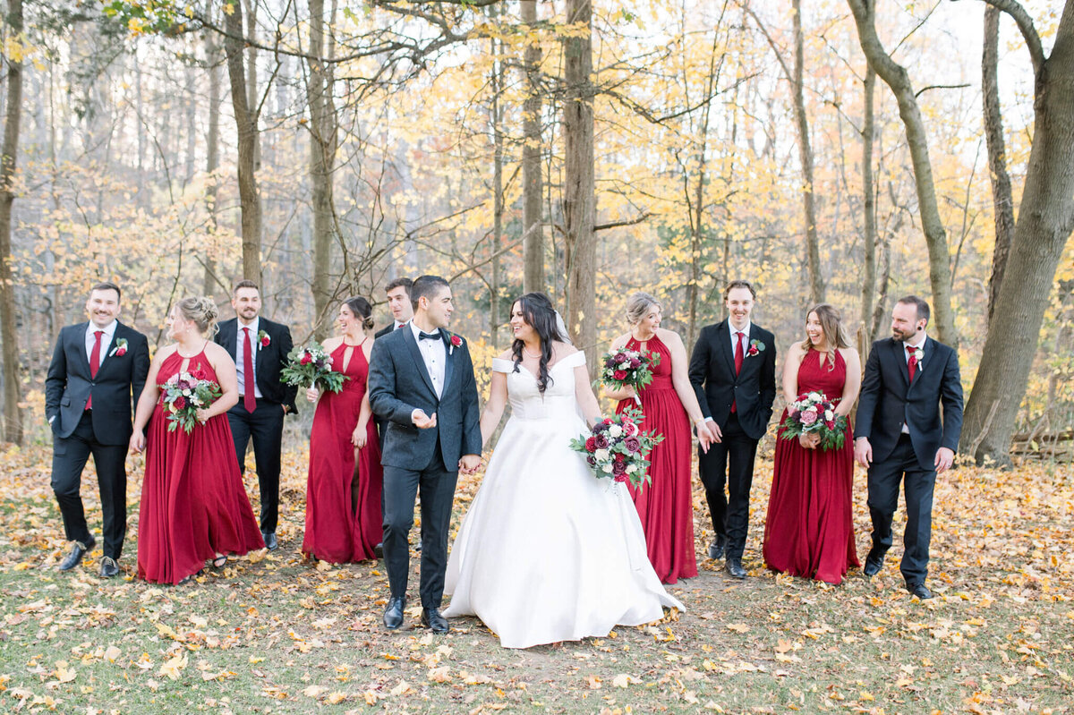 Bride and groom walking ahead of large wedding party