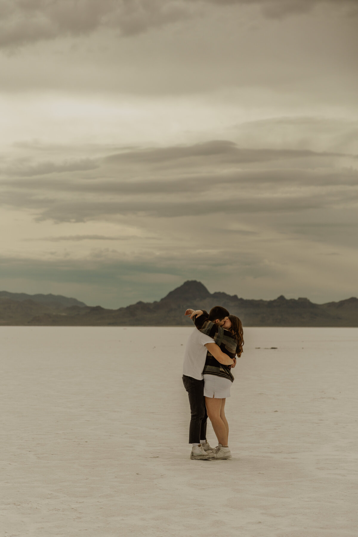Photo of couple hugging from a distance at the Utah Salt Flats 