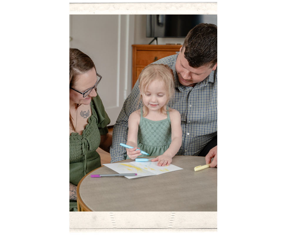 Family gets documented drawing a picture together.