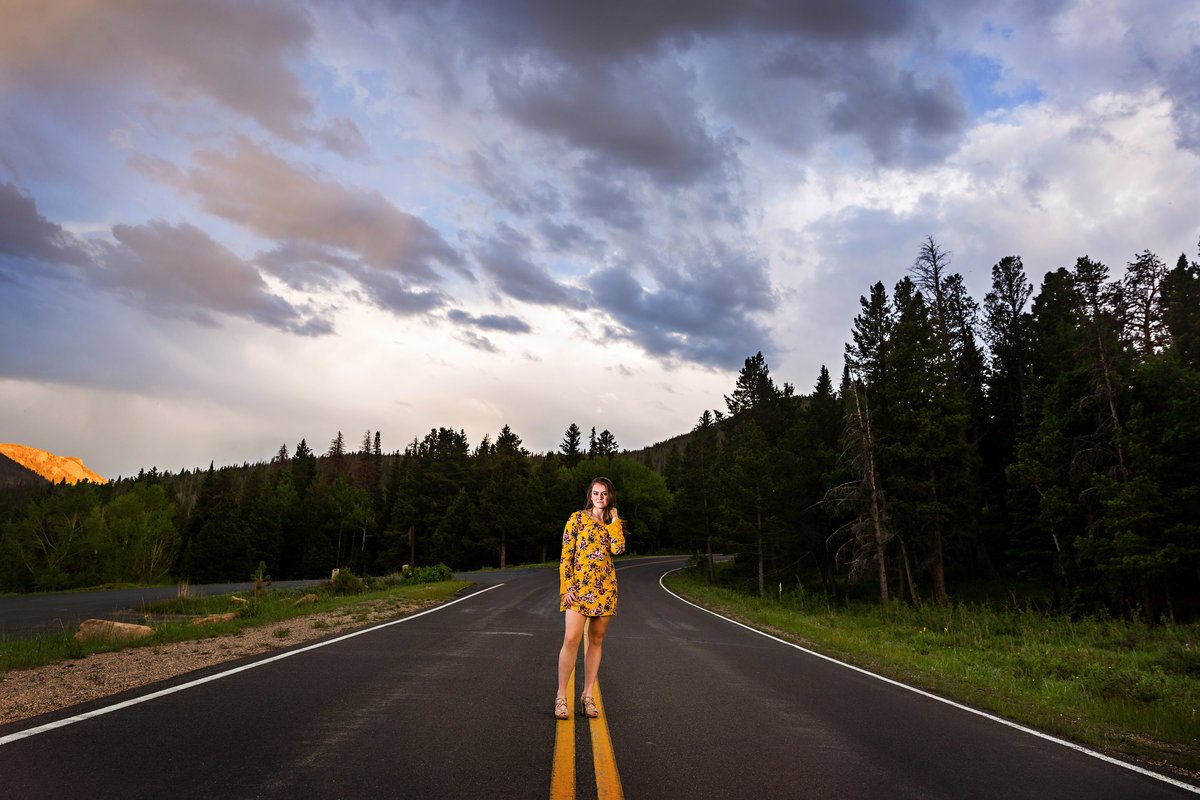 Girl stands in the road to her future for her graduation pictures