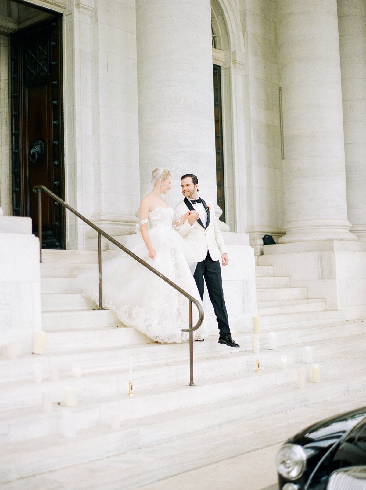 Bride and groom standing on cathedral stairs
