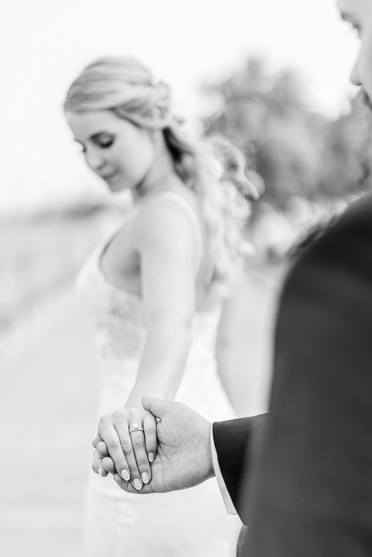 bride walking away while groom holds her ring hand
