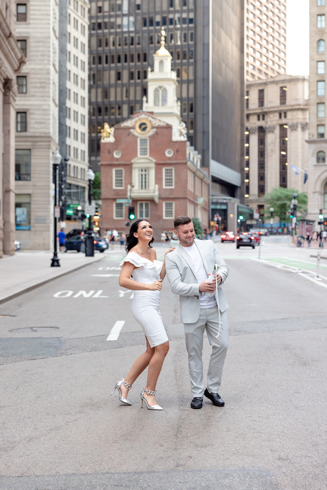 an engaged couple popping a bottle on champagne in Boston