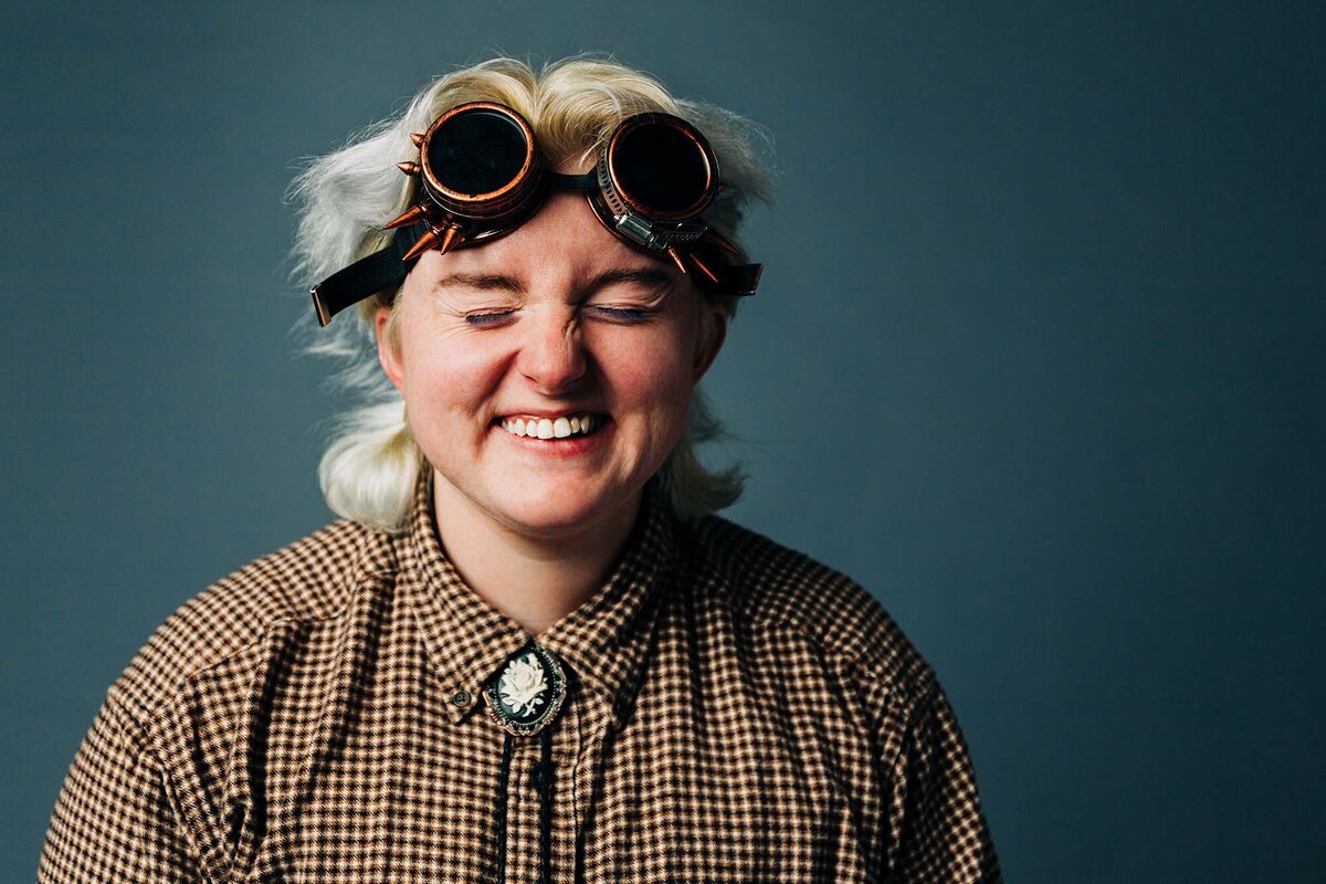 Studio headshot of University of Montana student with steampunk glasses