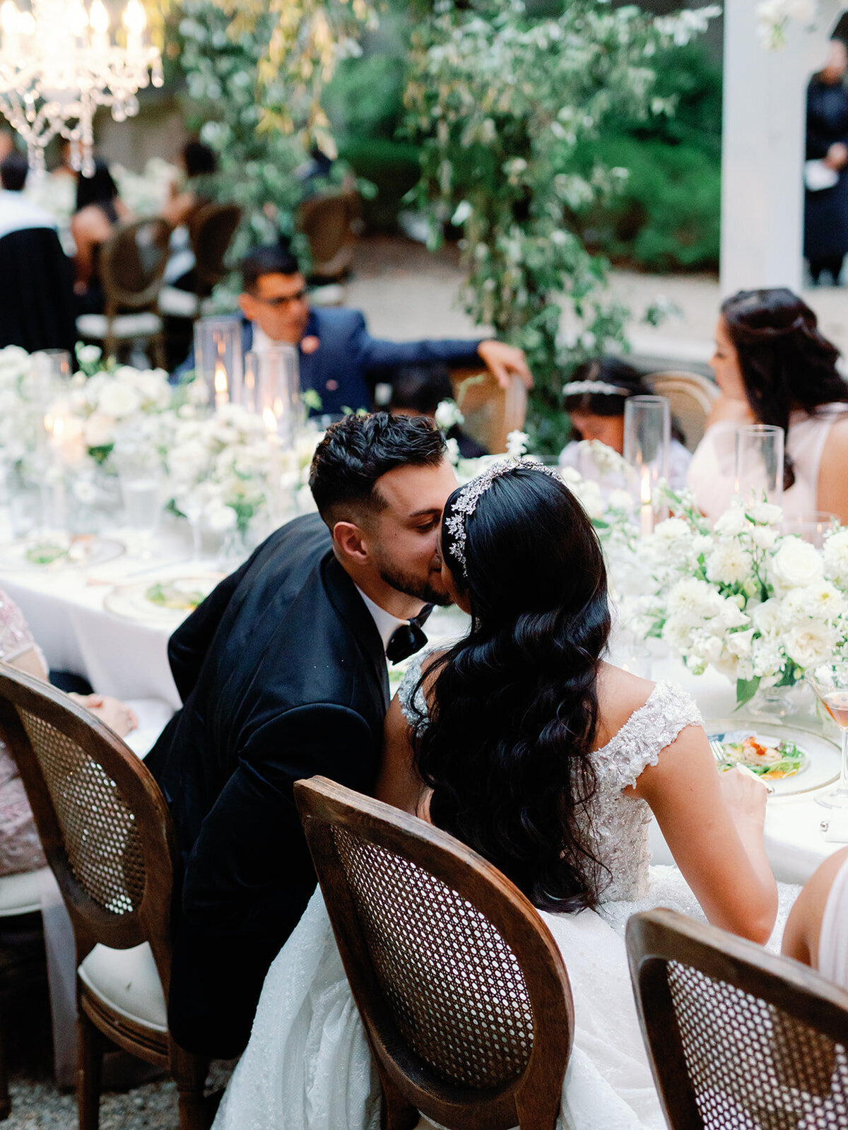 Bride and groom share a kiss at their reception