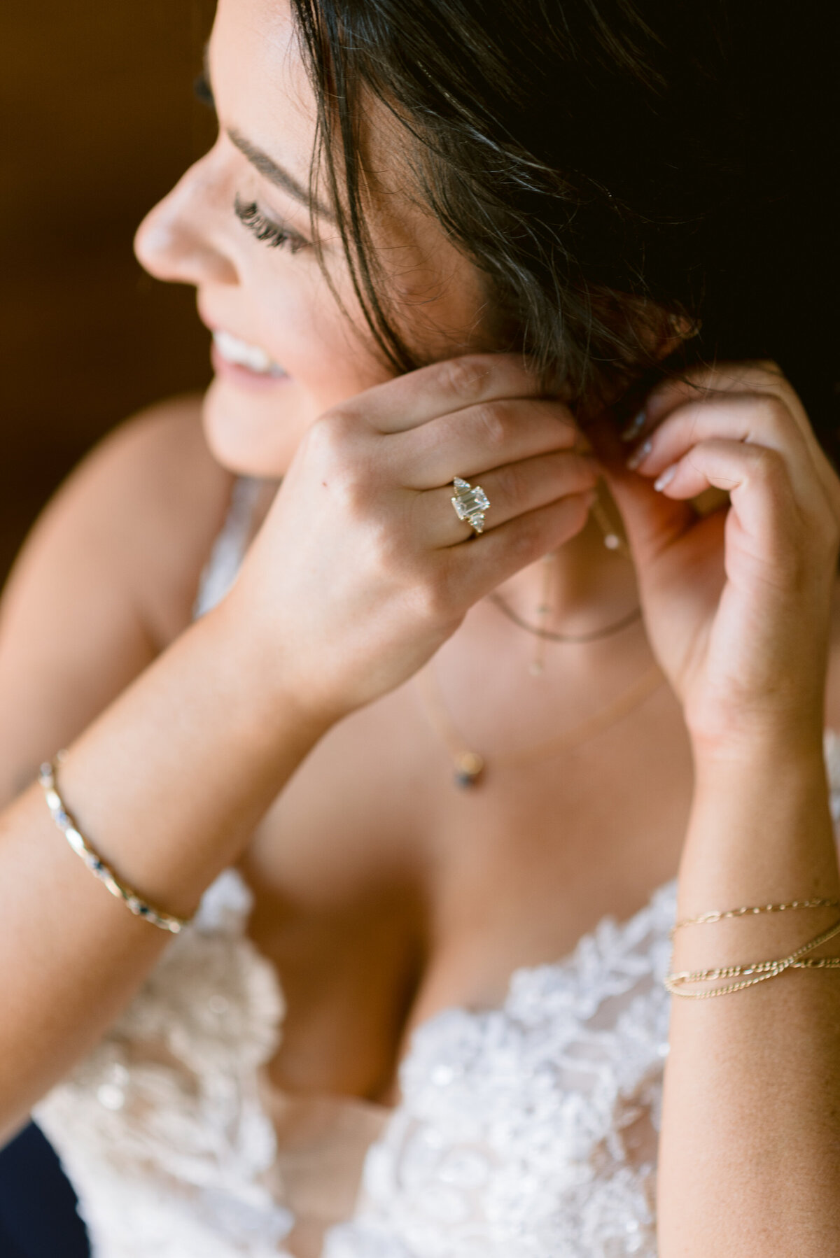 bride putting in earrings