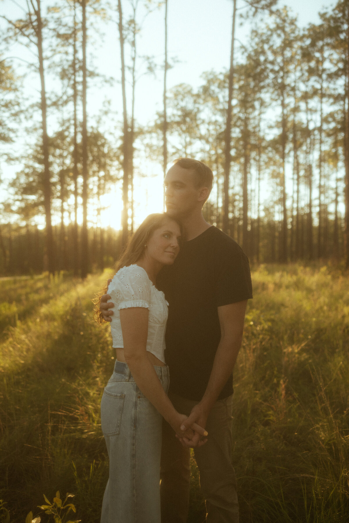 Couple posing for portraits in a forest.