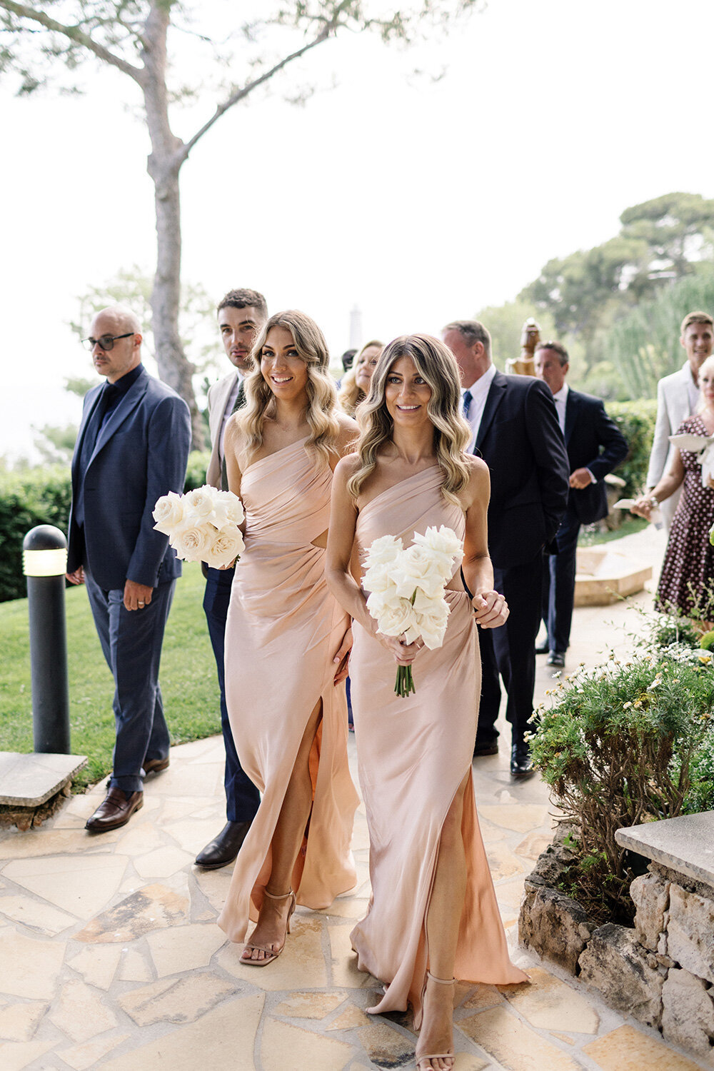 bridesmaids with hollywood waves and soft pink dresses