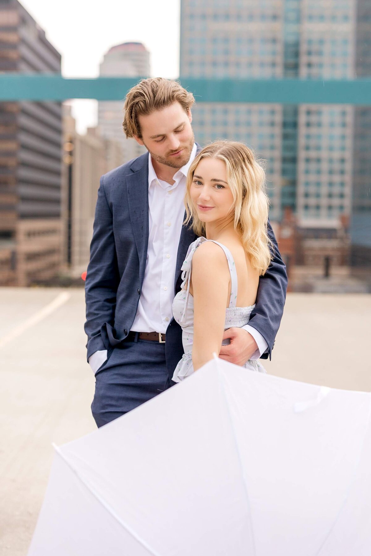 Rainy Minneapolis evening sets the stage for an urban engagement session, highlighting a modern couple's love