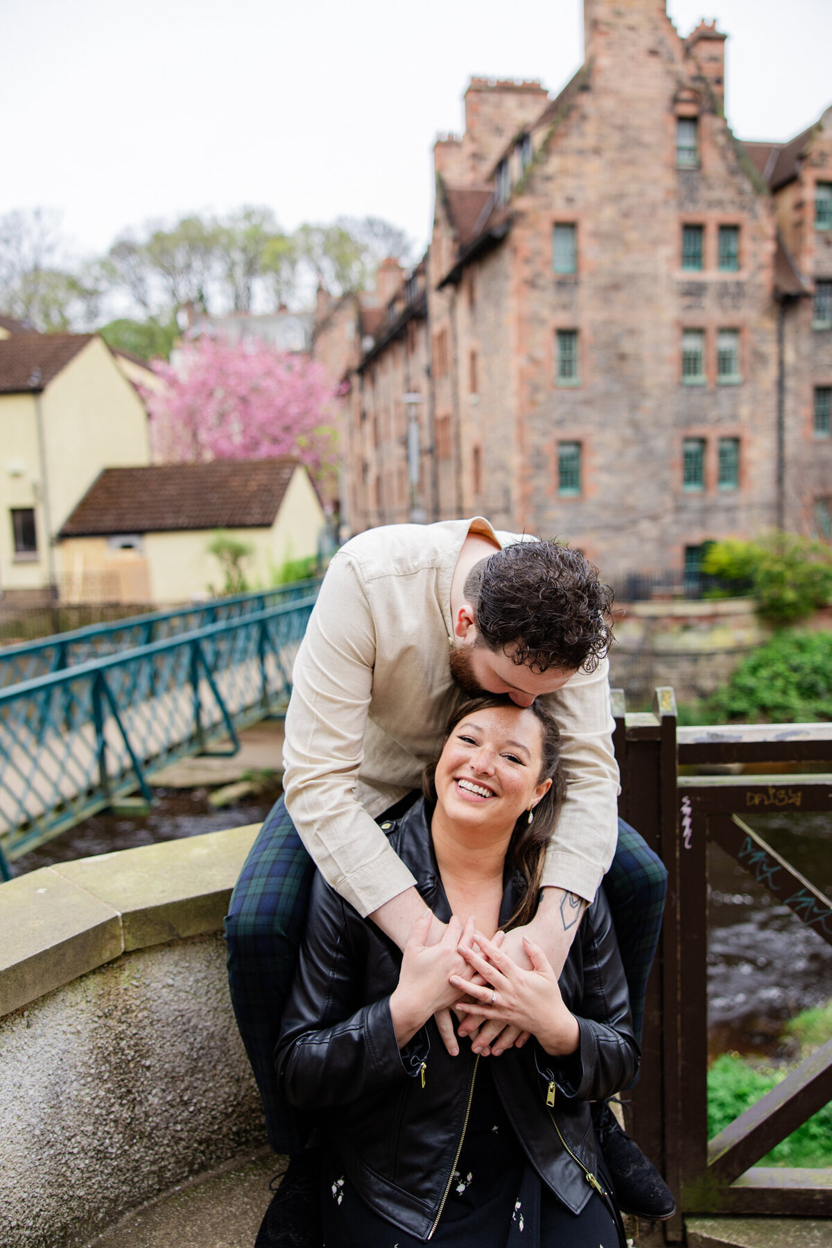 groom kisses the top of the brides head