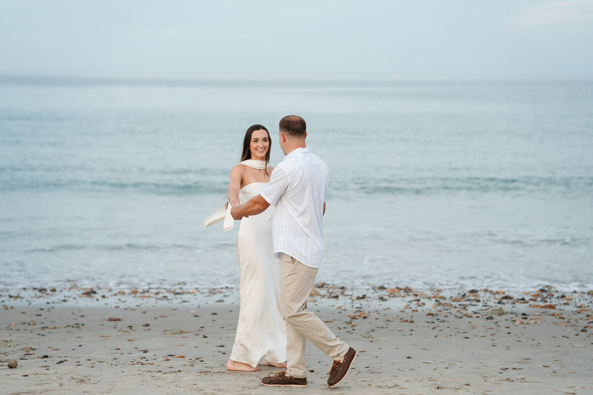 Romantic coastal engagement session in New England overlooking the shoreline.