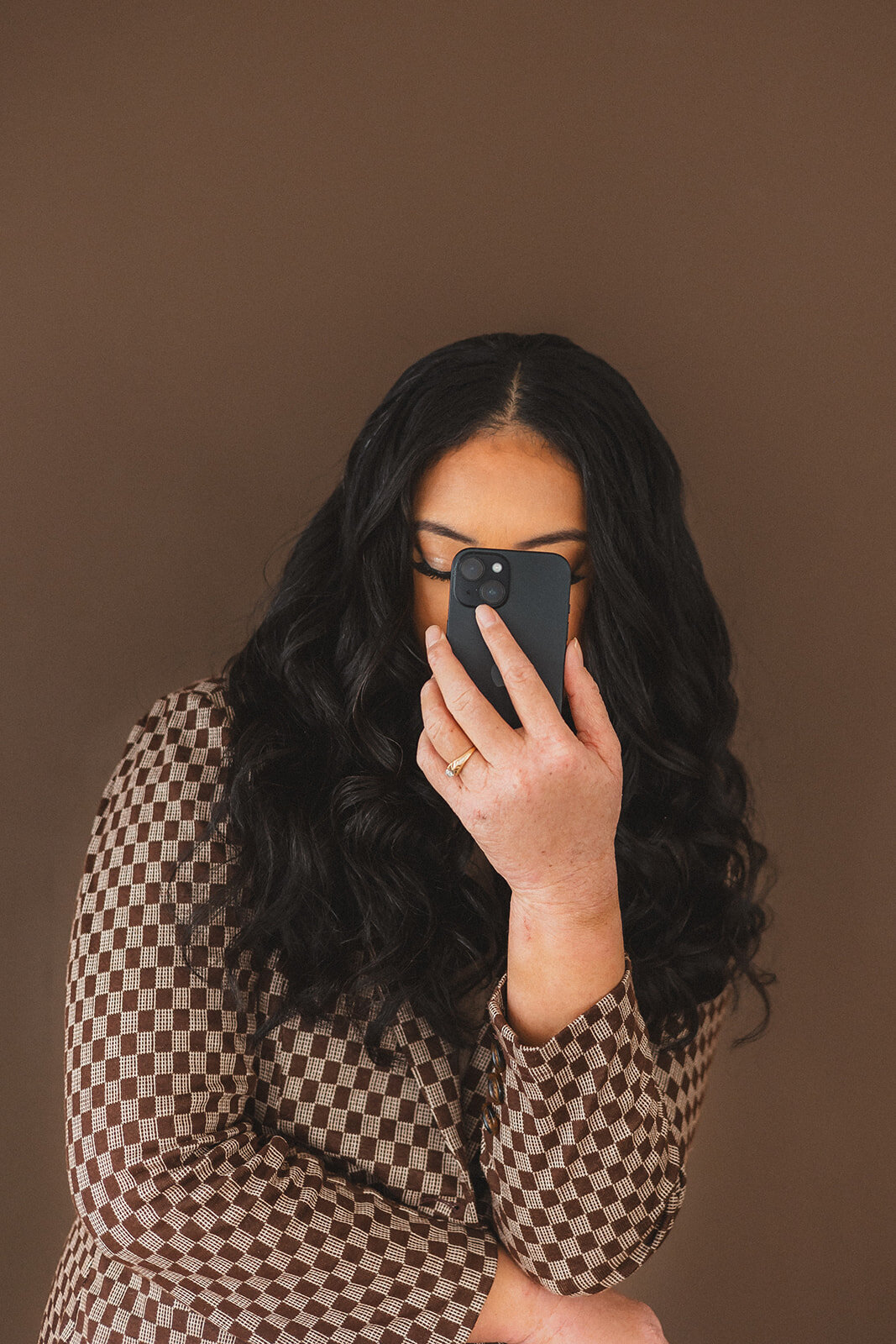A woman leans into her phone