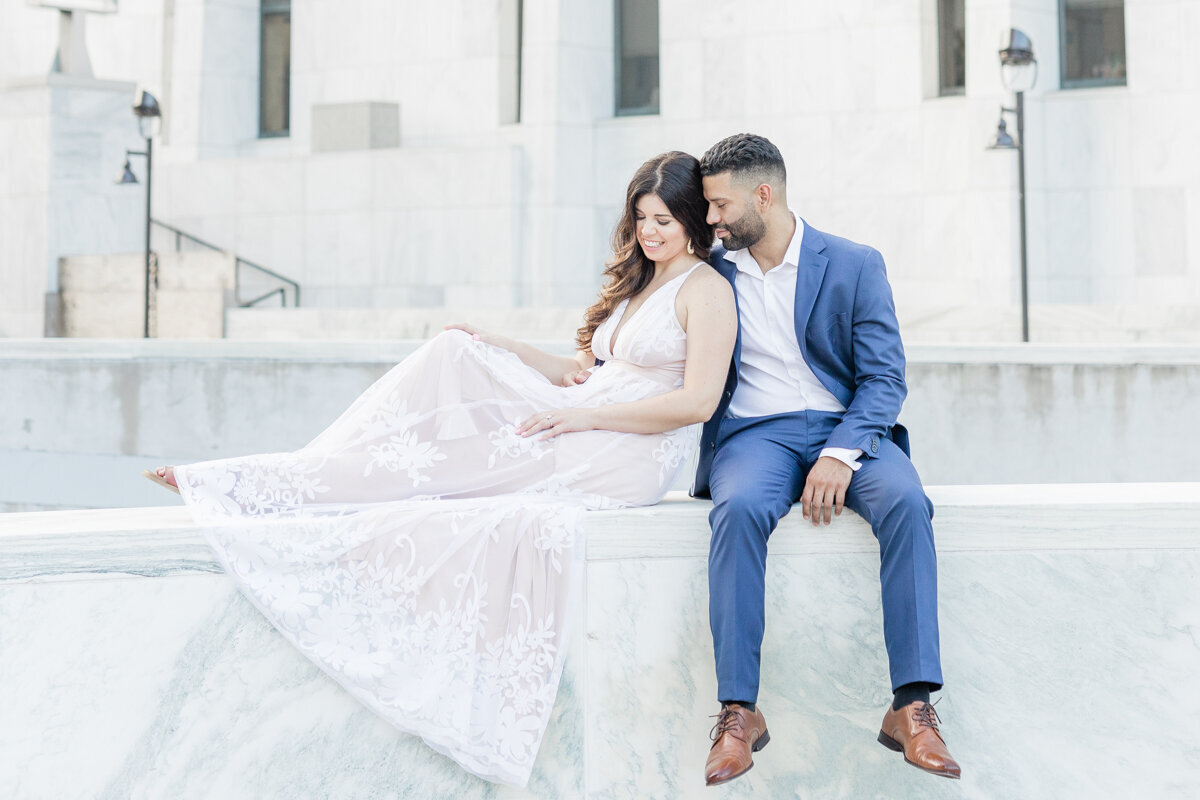 Elegant portrait of couple in a navy suite and white dress in Empire Plaza in Albany, NY