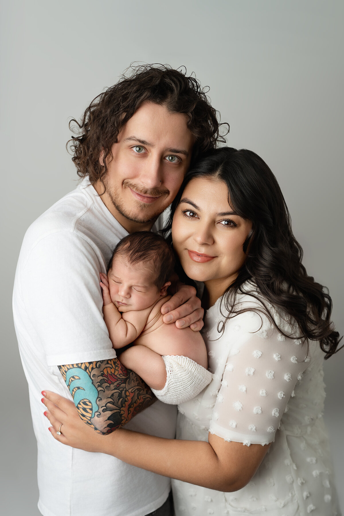 Close-up studio family portrait with parents holding newborn | Paris Ontario photographer