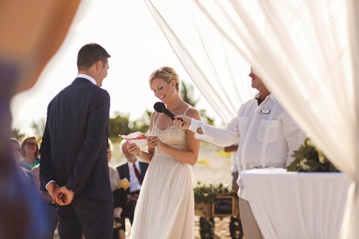 Bride reading vows at wedding in Cancun