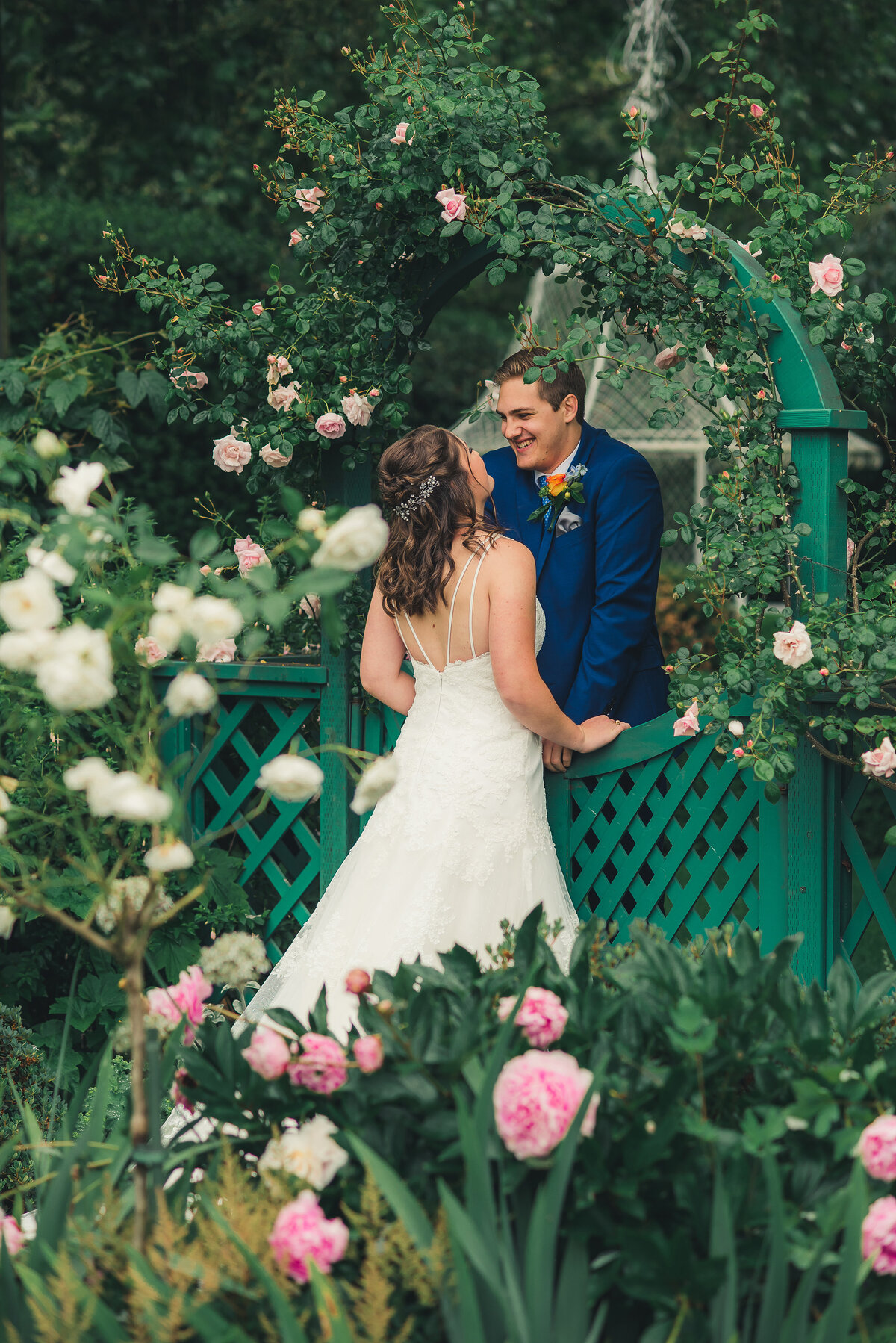 bride and groom in rose garden