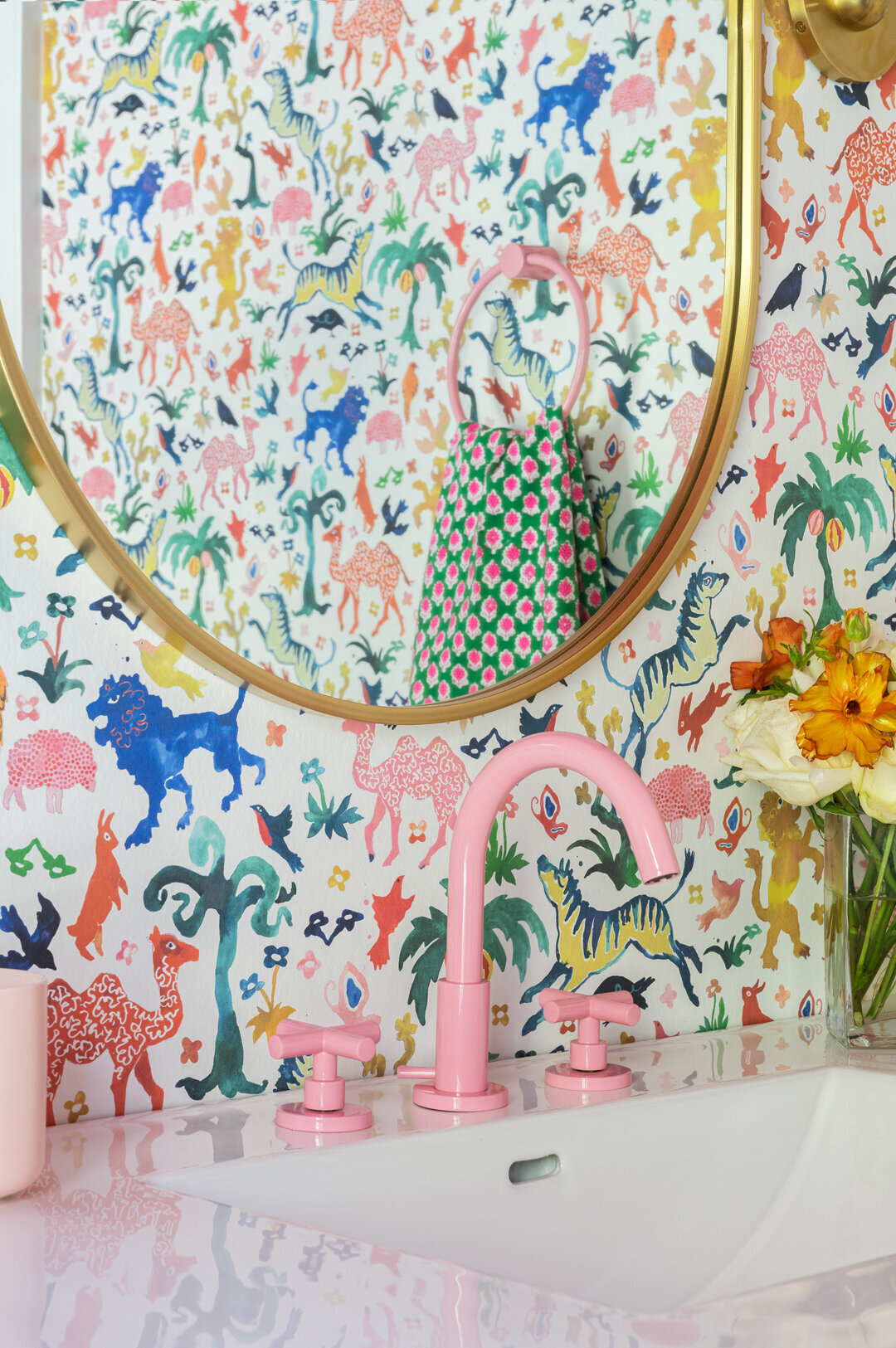 colorful animal patterned wallpaper with pink faucet