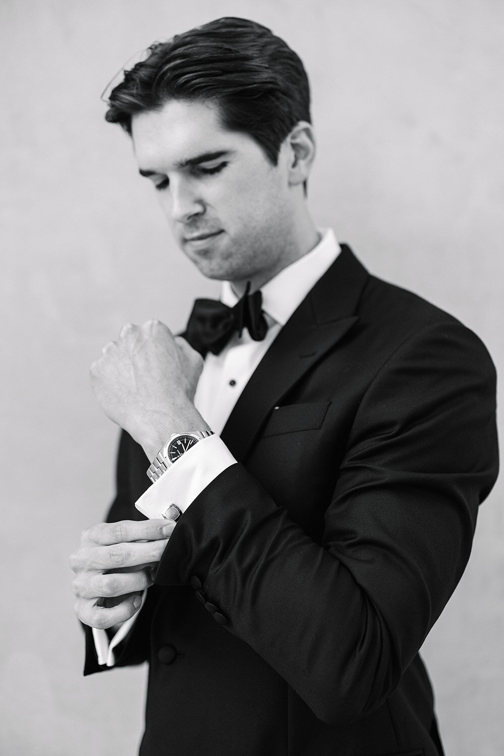 classic black and white photo of groom getting ready in mallorca
