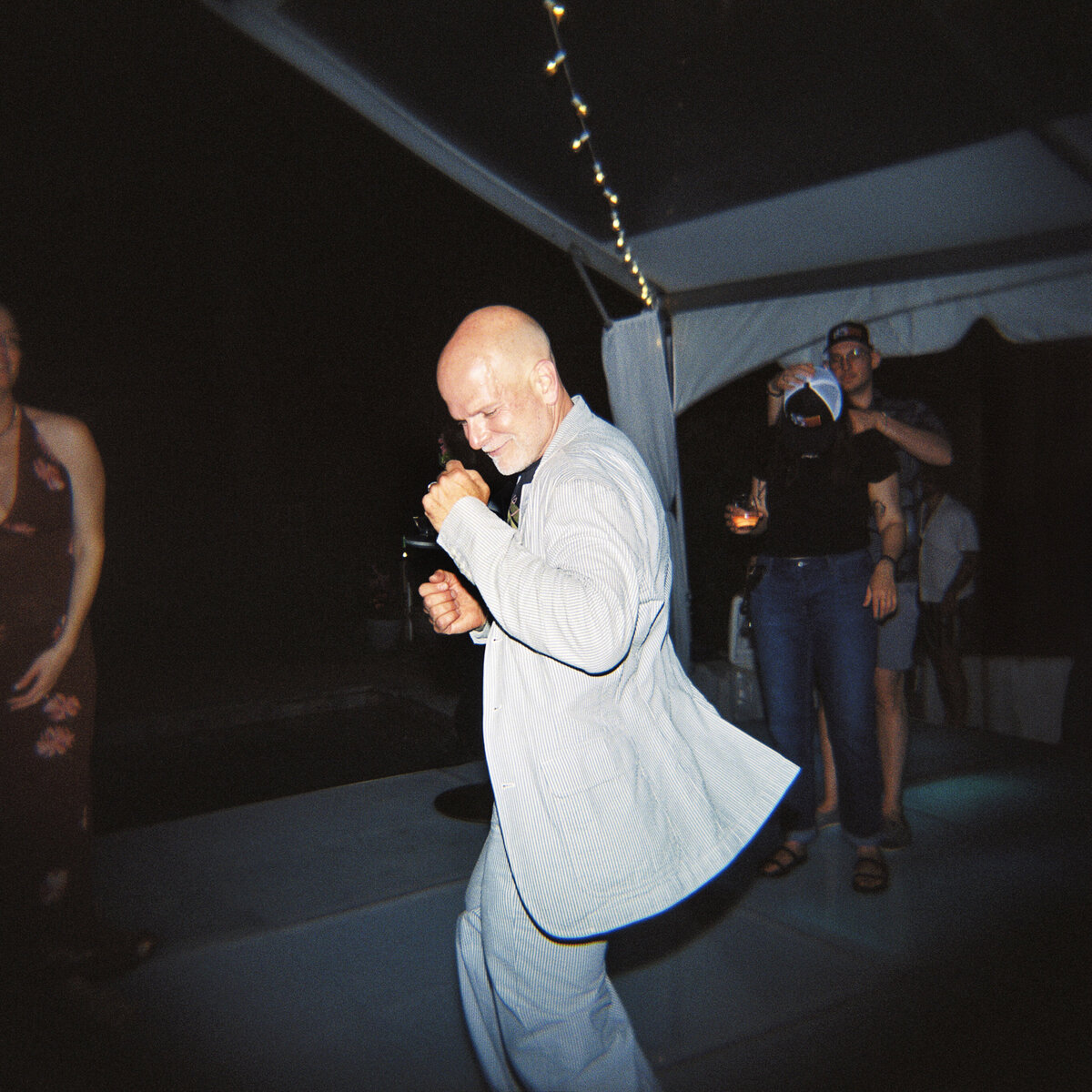 Photo of guest dancing on film in private backyard party by Mira Park Photography NY based wedding photographer